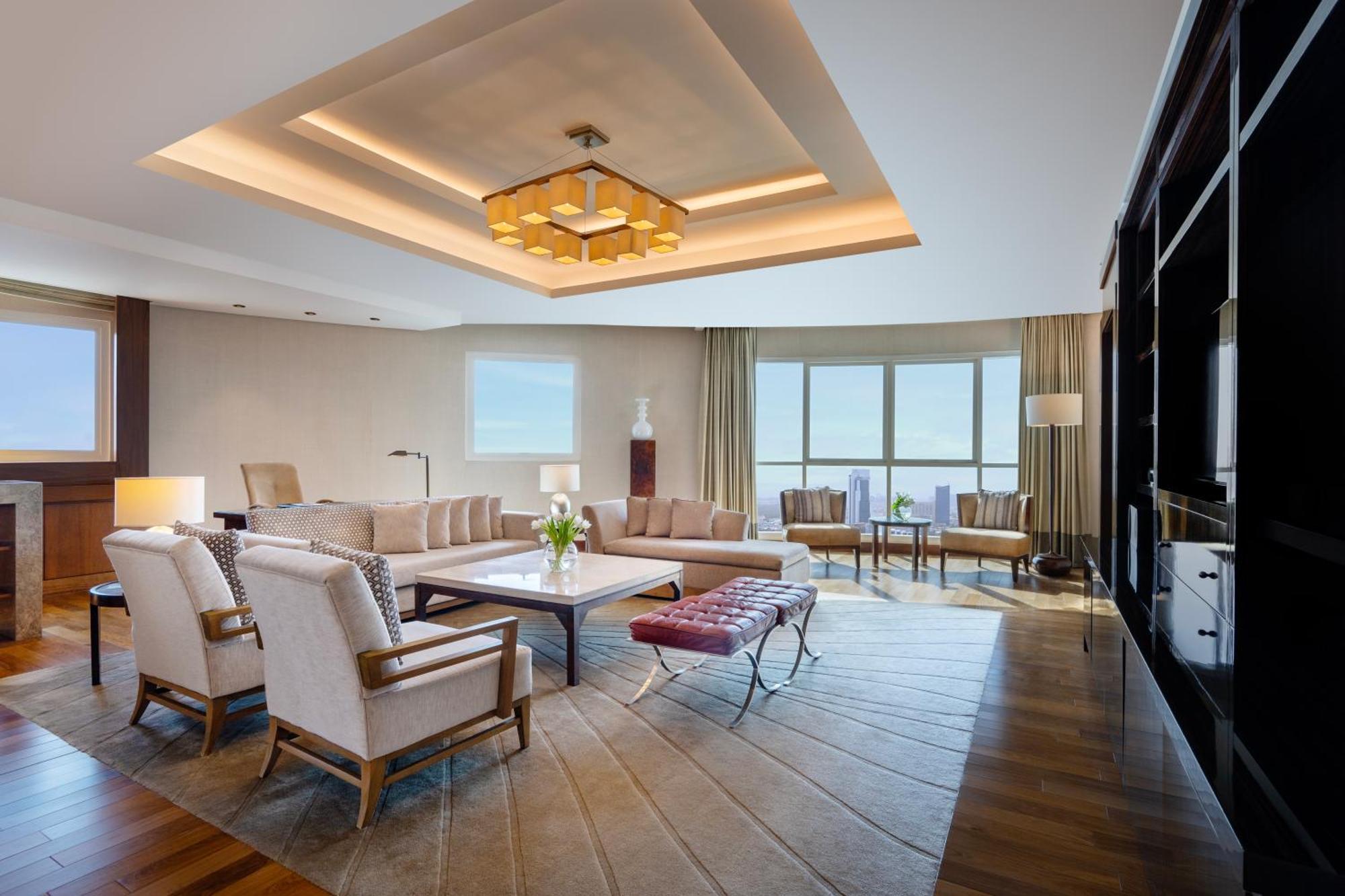Grand Millennium Al Wahda Hotel And Executive Apartments Abu Dhabi Exterior photo The photo shows a stylish and modern living room. It features a spacious layout with large windows that allow natural light to fill the space. The ceiling has an elegant design with integrated lighting, enhancing the ambiance. 

The furniture include